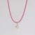 anhaenger_herzchen_925-silber_plastisch_geformtes_kleines_herz_mit_oese_auf_rotem_band_als_kette