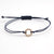 atelierCK_armband_mica_kreis_gelbgold_brillanten_weiß_textilband_dunkelblau_liegend